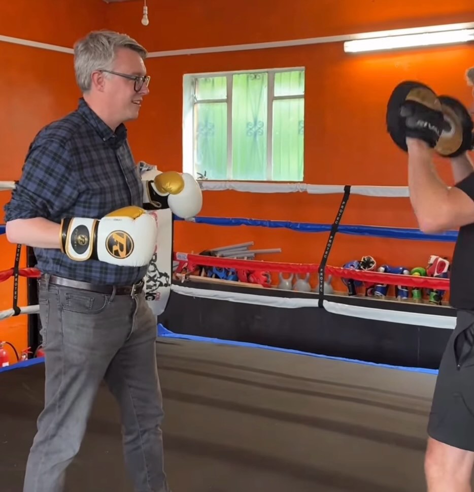 Martin McCluskey trying boxing pads during a visit to Port Glasgow Victoria Amateur Boxing Club